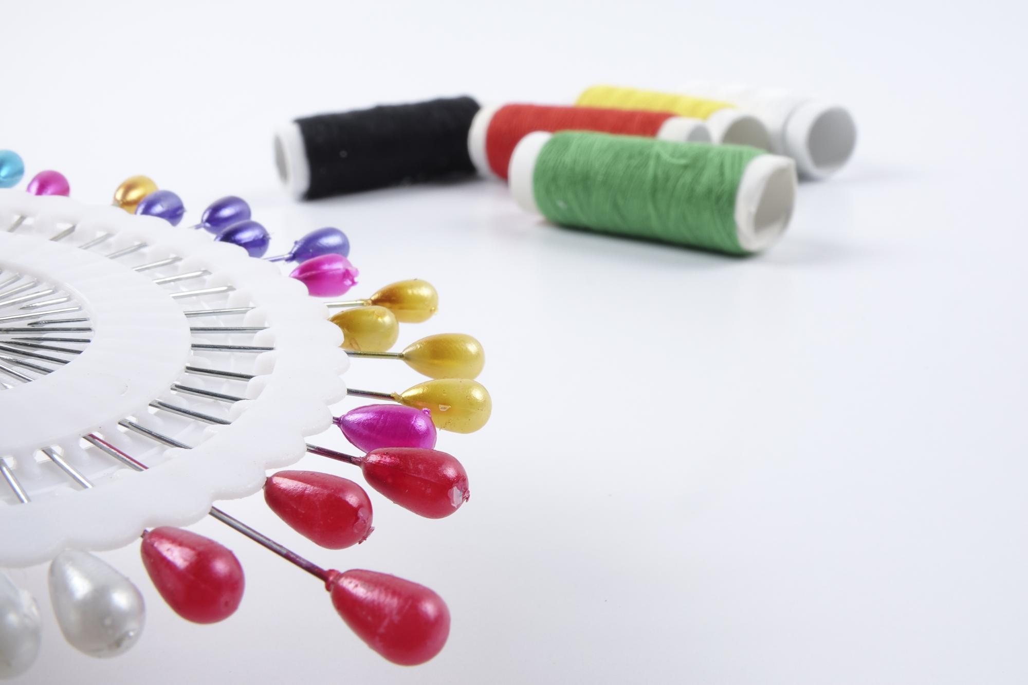 Macchina da ricamo con filati colorati su tavolo da lavoro